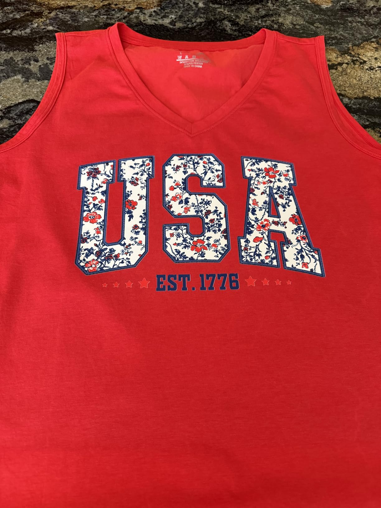 Finished red sleeveless shirt with a large USA floral transfer