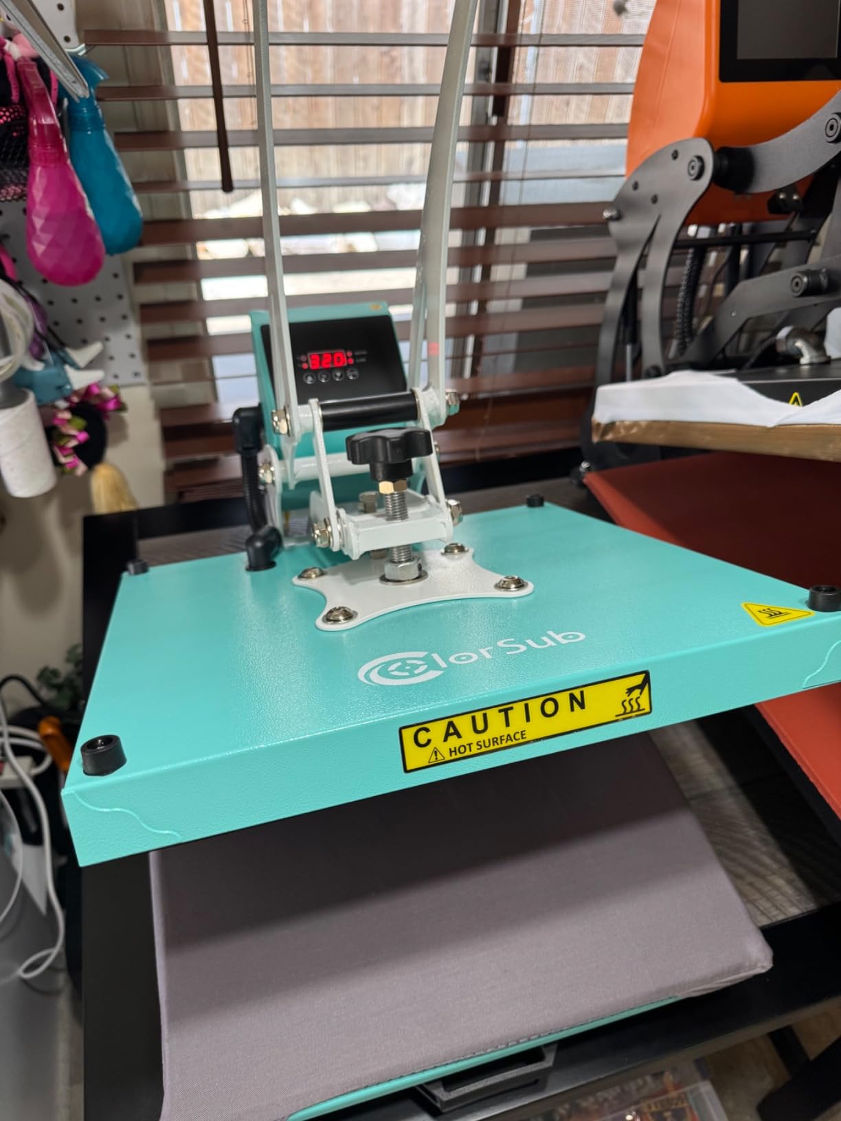Teal ColorSub flat heat press photographed in a craft workspace