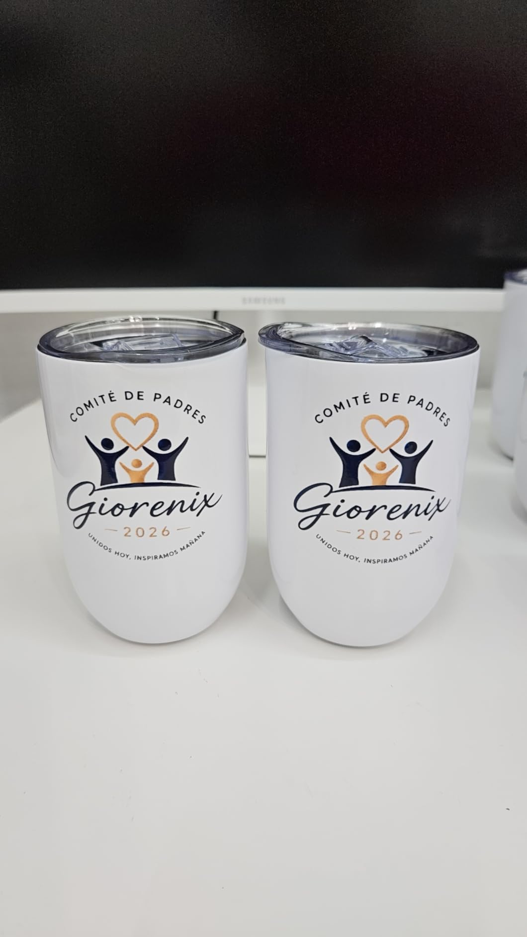 Two personalized white 12 ounce tumblers with matching dark blue and gold designs